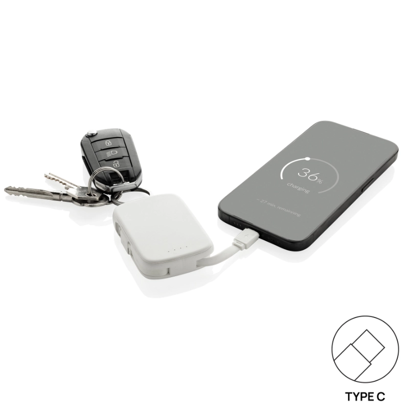 Gadget powerbank portachiavi Nexo RCS in fase di ricarica di un telefono cellulare con connettore Type-C.